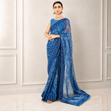 Zarfina blue digital printed chiffon saree with raw silk blouse, worn by a model in a formal setting.