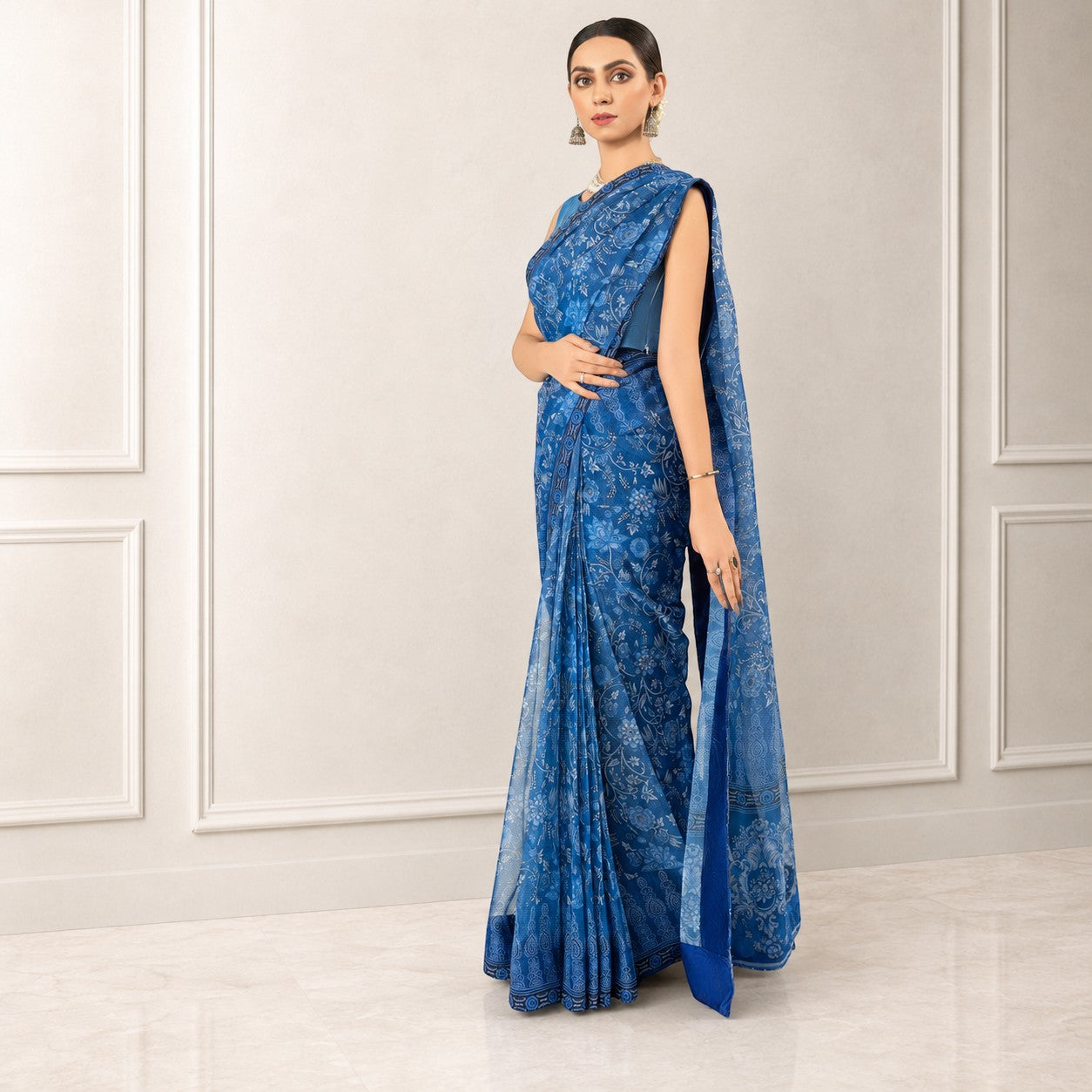 Zarfina blue digital printed chiffon saree with raw silk blouse, worn by a model in a formal setting.