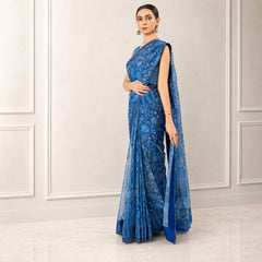 Zarfina blue digital printed chiffon saree with raw silk blouse, worn by a model in a formal setting.