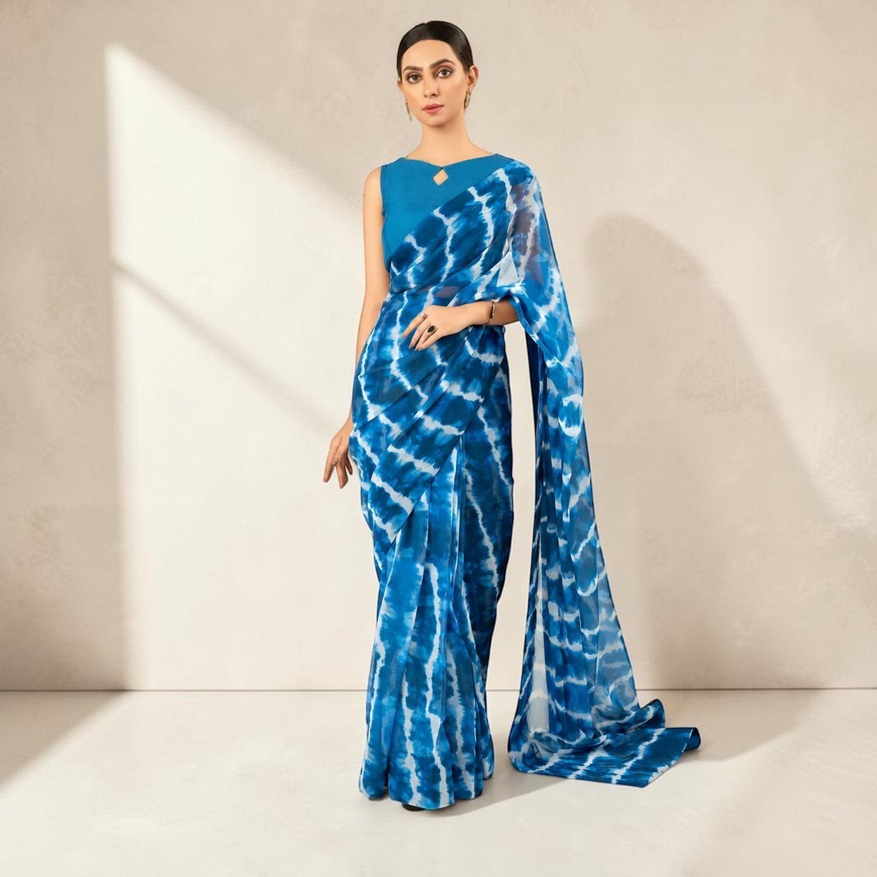 Zarfina blue chiffon saree with digital tie-dye print and matching sleeveless raw silk blouse for formal occasions