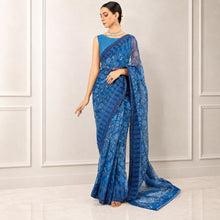 Zarfina blue digital printed chiffon saree with a matching raw silk blouse worn by a model in a formal setting.