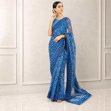 Zarfina blue digital printed chiffon saree with raw silk blouse worn by a model in a formal setting.