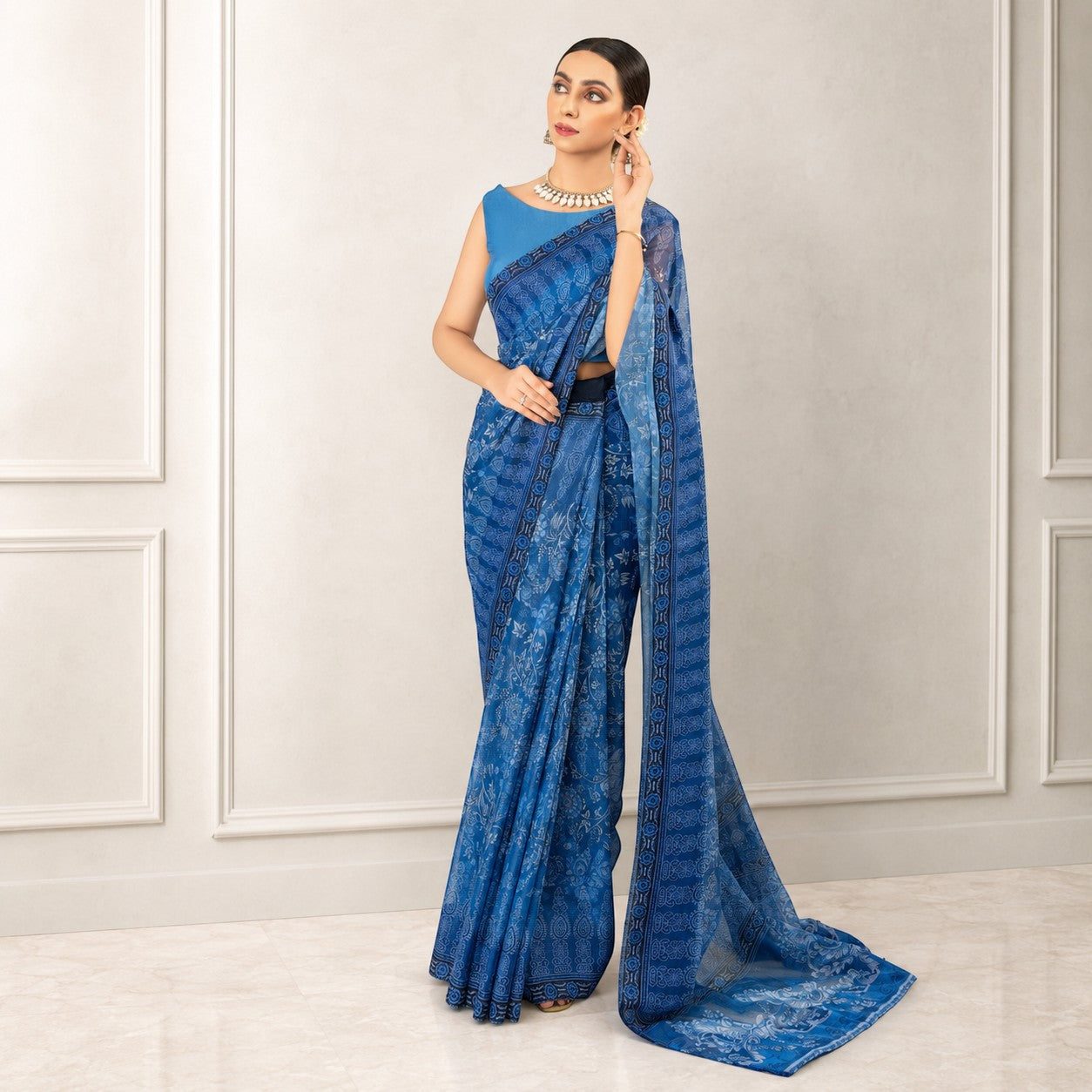 Zarfina blue digital printed chiffon saree with raw silk blouse worn by a model in a formal setting.