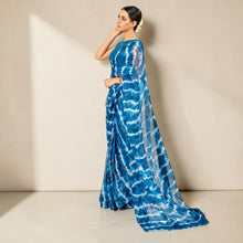 Zarfina digital printed blue and white chiffon saree with raw silk blouse worn by a model in a studio setting