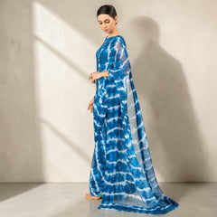 Zarfina blue and white digital printed chiffon saree with raw silk blouse, worn by a model in a studio setting.