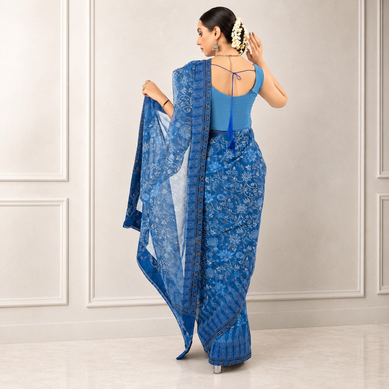 Zarfina blue digital printed chiffon saree with a raw silk blouse, shown from the back on a model.