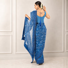 Zarfina blue digital printed chiffon saree with a raw silk blouse, shown from the back on a model.