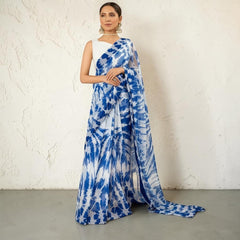 Zarfina digital printed blue and white chiffon saree with a sleeveless raw silk blouse worn by a model in an archway.