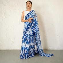 Zarfina digital printed blue and white chiffon saree with a sleeveless raw silk blouse for formal occasions.