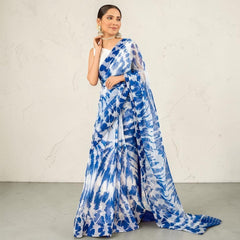 Zarfina digital printed blue and white chiffon saree with a raw silk blouse worn by a model.