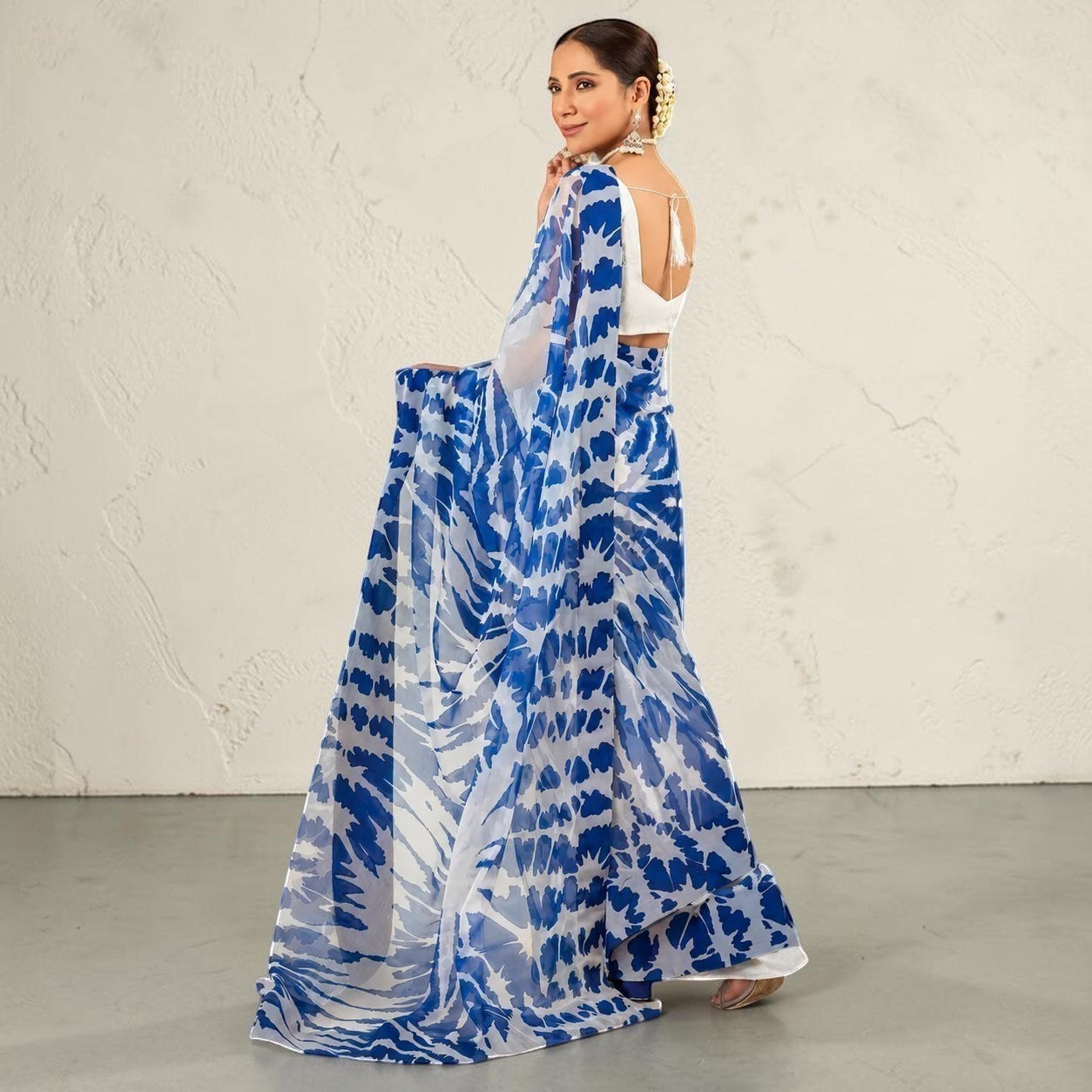 Zarfina digital printed blue and white chiffon saree with raw silk blouse worn by a model in a studio setting