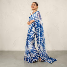 Zarfina digital printed blue and white chiffon saree with raw silk blouse, worn by a model in a formal setting.