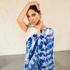 Zarfina digital printed blue and white chiffon saree with a raw silk blouse worn by a model in a formal setting.