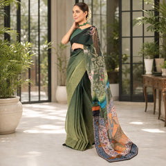 Zarfina digital printed chiffon saree in olive green with raw silk blouse, worn by a model in a bright indoor space.